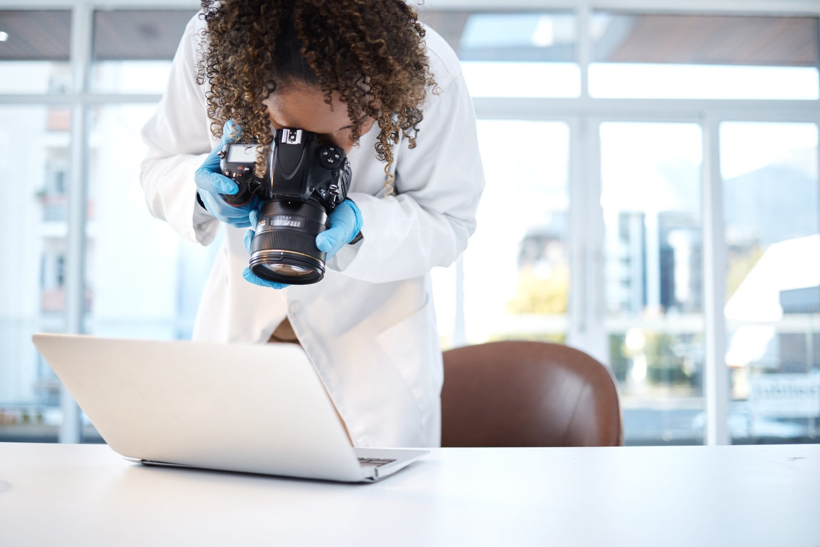 Science investigation, camera and black woman with laptop in laboratory for forensic research with .